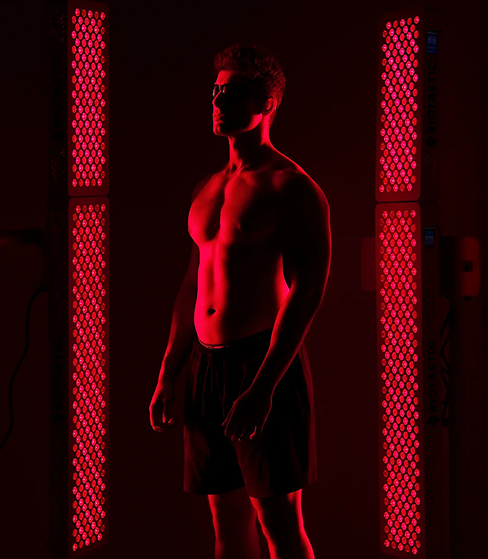 Man standing between red light therapy panels